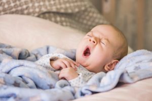 How Your Baby’s Sleep Cycle Differs From Your Own A baby yawning