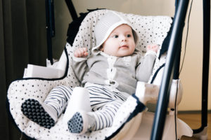 Can Babies Sleep in a Swing? Cute baby sitting in a high chair, swings