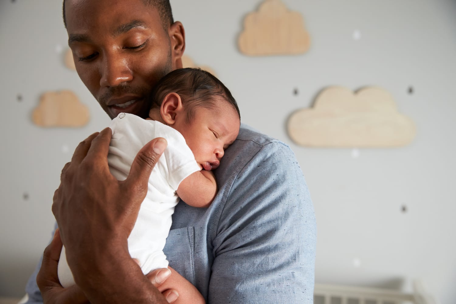 Understanding Sleep Deprivation and New Parenthood Father holding son