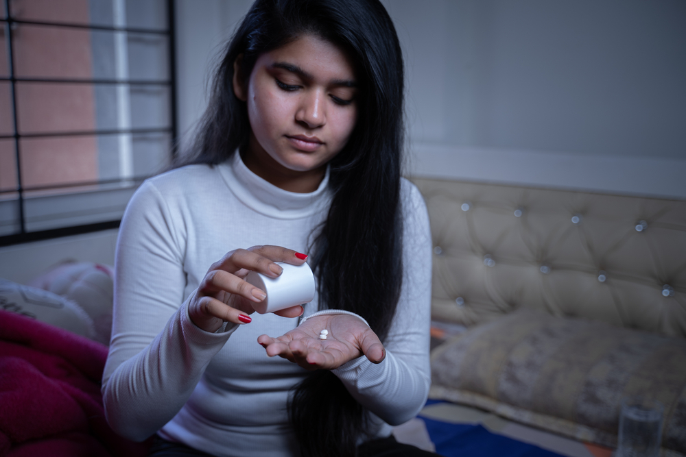 Young girl taking medication before bed