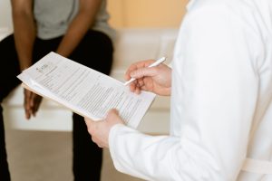 STOP-Bang Score Healthcare professional reviews medical form during patient consultation in a clinic setting