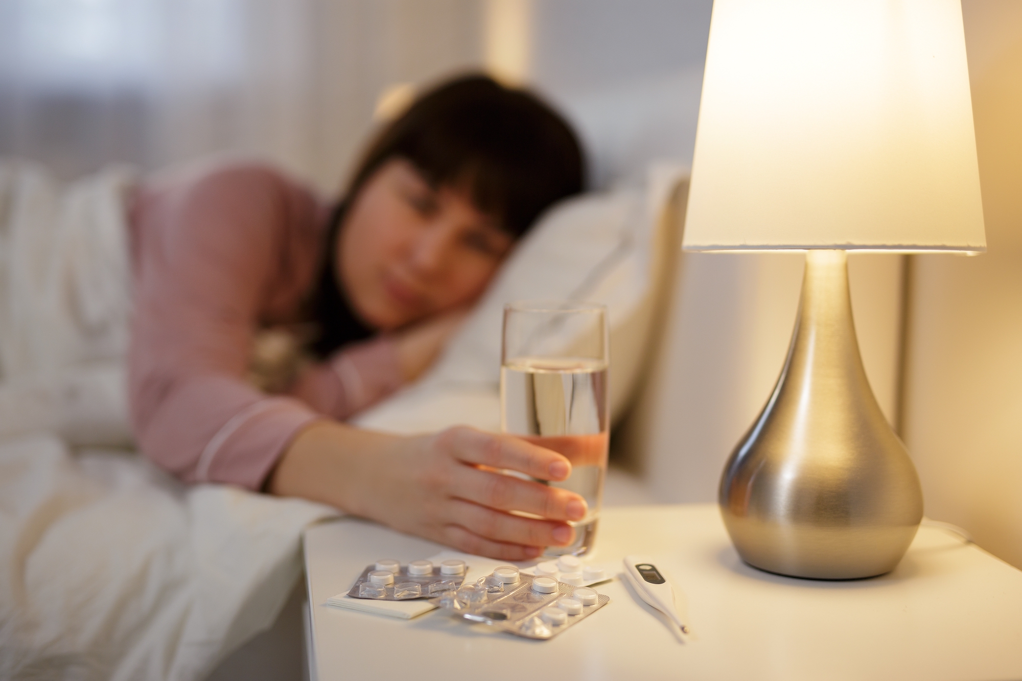 Woman taking nighly melatonin