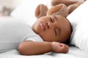 4-Month Sleep Regression Cute infant baby sleeping on bed
