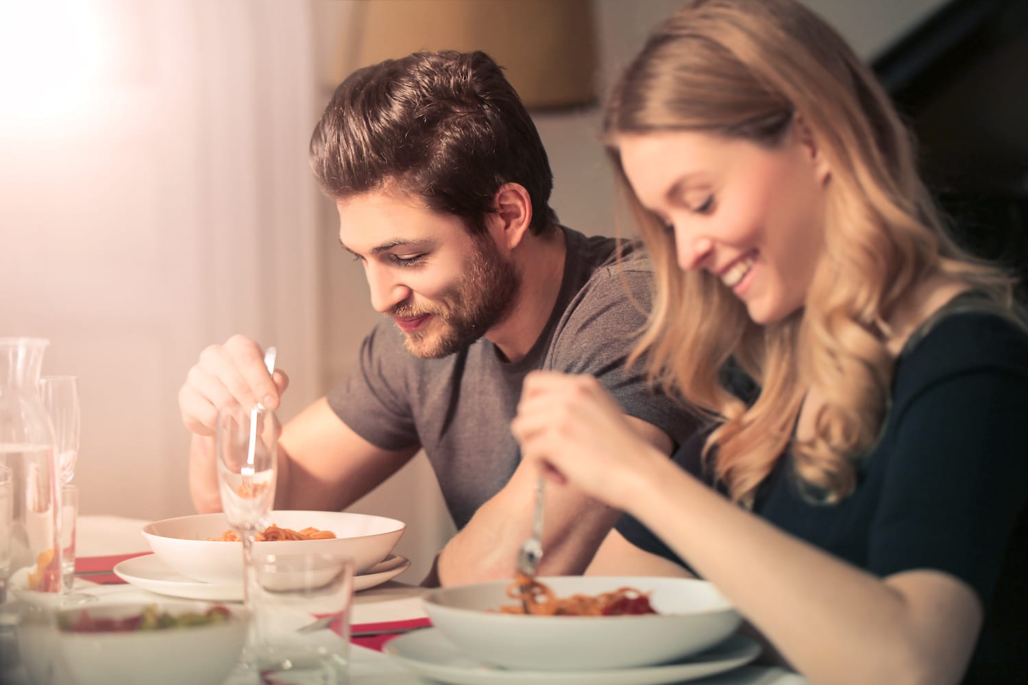 Lack of Sleep May Increase Calorie Consumption couple eating dinner