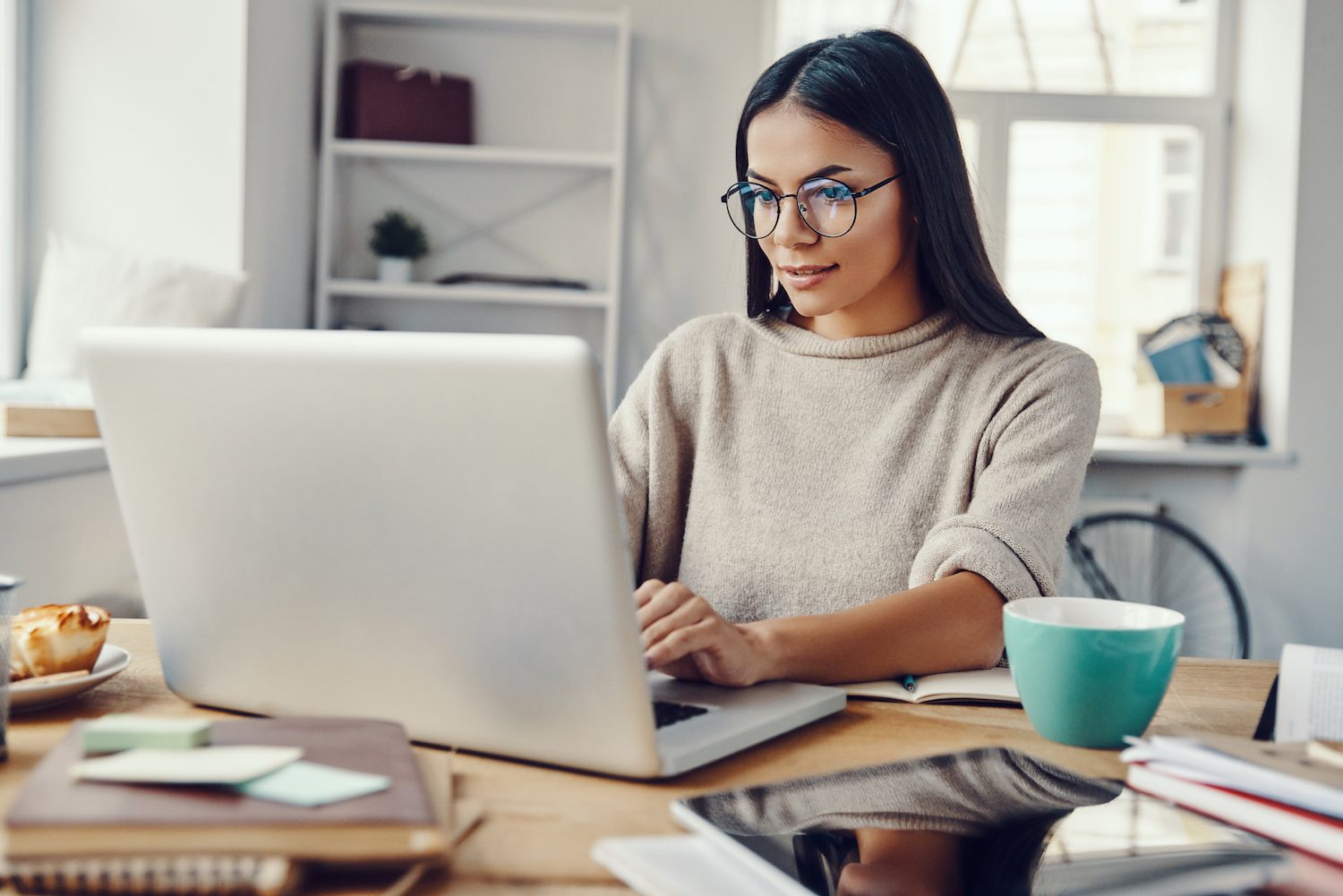Sleepless Nights: How to Function on No Sleep Woman working at home with a coffee