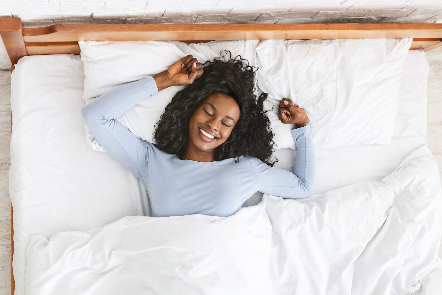 Starfish Sleeping Position Woman sleeping in starfish position in bed