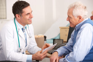 man talks with his doctor about sleep apnea