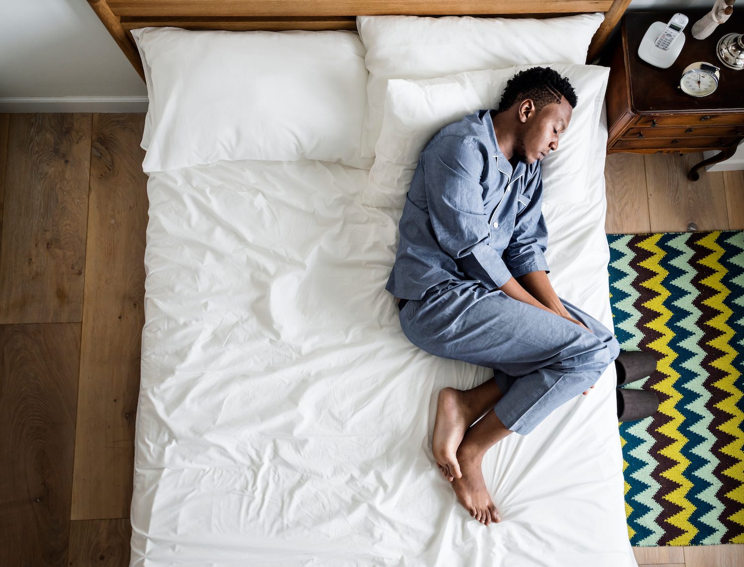 What Your Sleep Position Means Man sleeping on side in bed