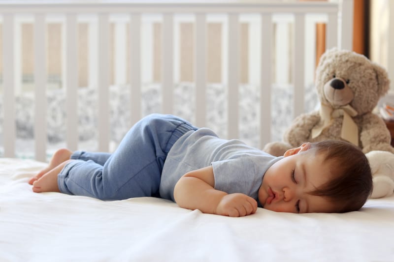 A baby sleeping in a crib